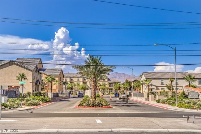 View of road featuring street lights, traffic signs, and a residential view | Image 23