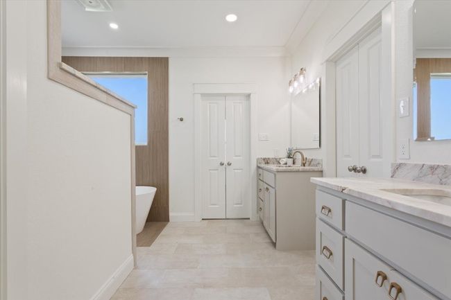 Bathroom with two vanities, a freestanding bath, and recessed lighting | Image 22