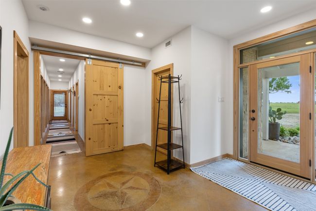 Entrance foyer featuring recessed lighting, concrete flooring, and a barn door | Image 10