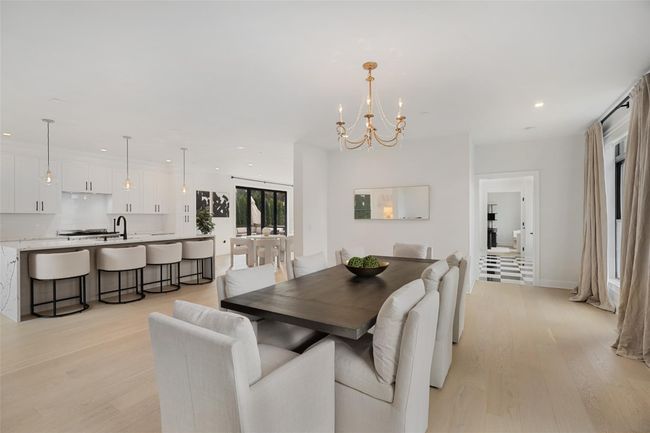 Dining room featuring an inviting chandelier, recessed lighting, and light wood-style floors | Image 6
