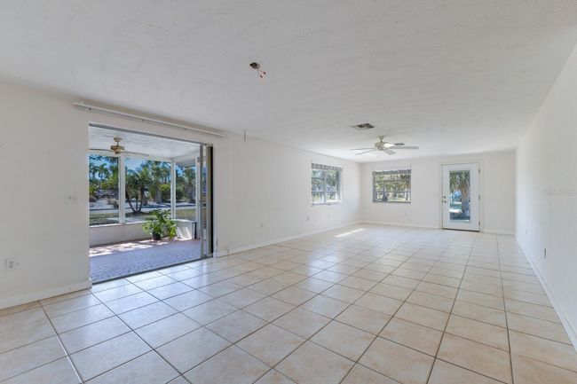The great room and dining room connect seamlessly to the lanai via a pocketed slider door. | Image 7