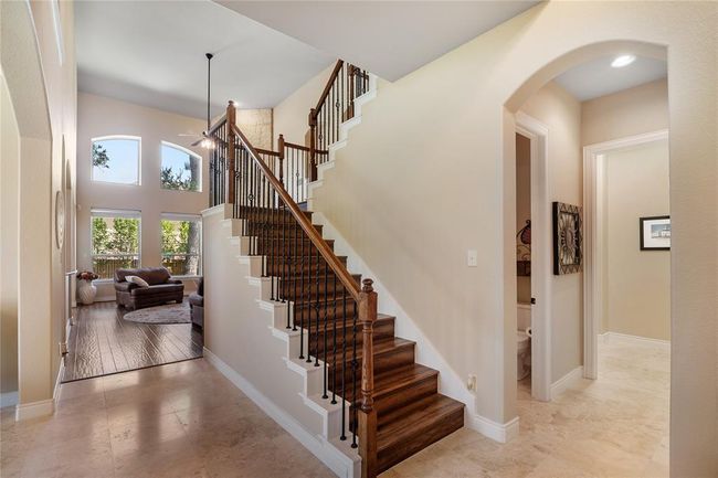 Impressive main entrance with travertine flooring. At your right is the garage entrance, oversized laundry room, seamless half bathroom and the grandiose stairs with an open view. impressive engineered hardwood floors. | Image 4