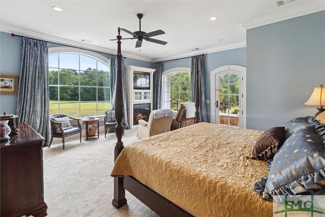 The natural light fills this room. An electric fireplace adds comfort on cold winter mornings while you sit and read or enjoy the views outside. | Image 22