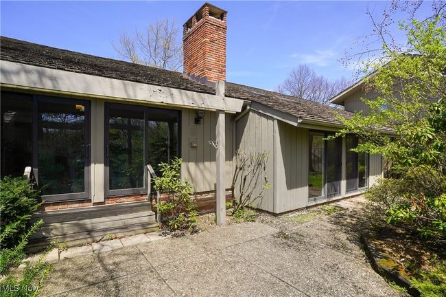 Back of property featuring a chimney and a patio area | Image 11