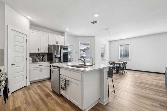 Cooking just got a whole lot easier with a center island, custom cabinetry, and a walk-in pantry. | Image 20