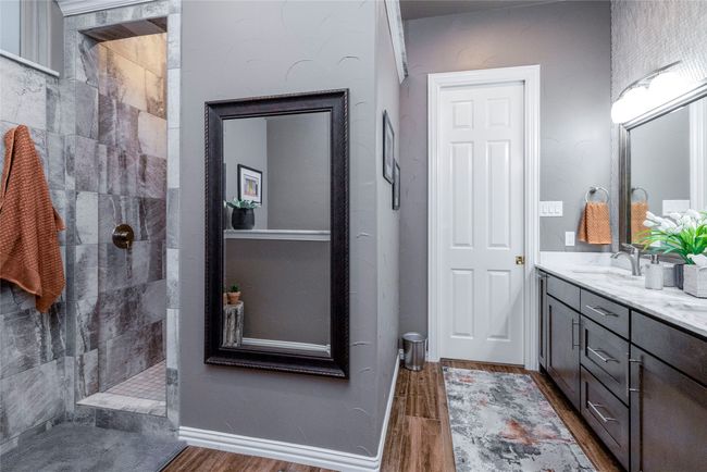 Ensuite bathroom with double vanity, marble counters and a large walk in shower | Image 21