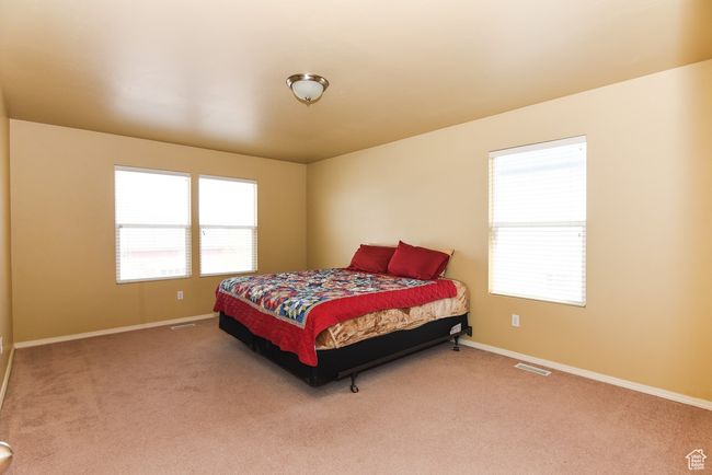 Bedroom with baseboards, visible vents, and carpet floors | Image 19