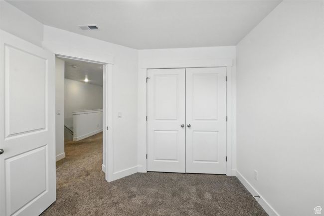 Unfurnished bedroom featuring carpet flooring and a closet | Image 13