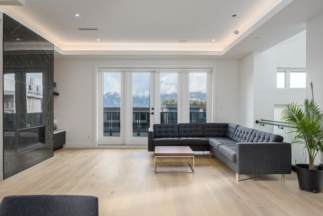 Living room featuring a tray ceiling, recessed lighting, baseboards, and light wood finished floors | Image 12