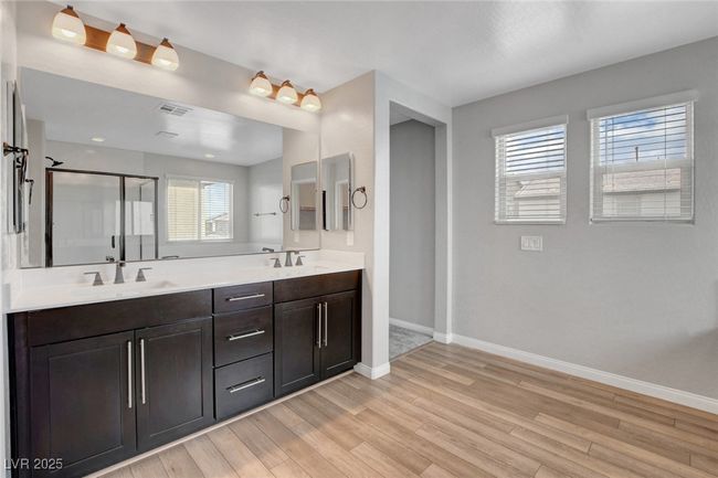 Bathroom with baseboards, wood finished floors, a stall shower, and healthy amount of natural light | Image 45