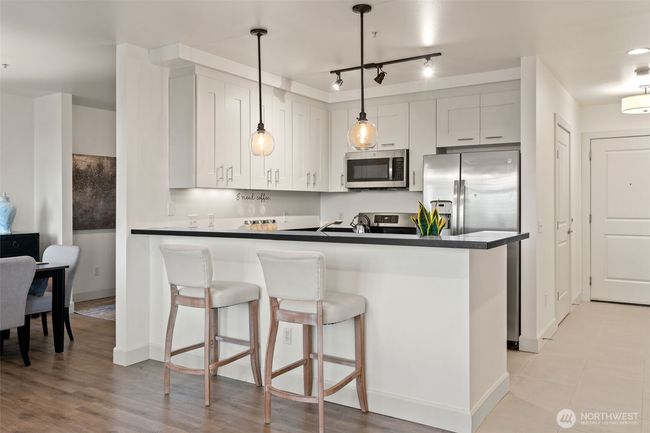 Kitchen with breakfast bar. | Image 12