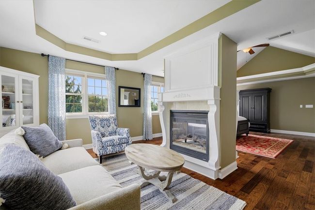 A comforting sitting room off the master bedroom is an ideal place to relax and read a book in front of the cozy fireplace. | Image 24