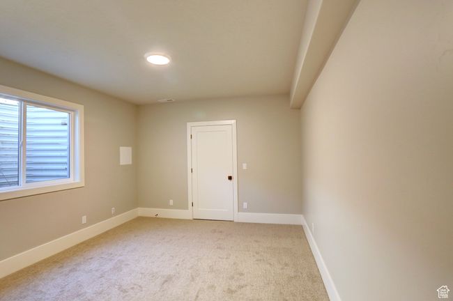 Unfurnished room with light colored carpet and baseboards | Image 33