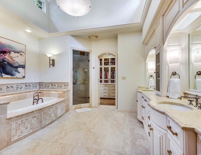 Full primary bathroom includes soaker tub and separate shower with a double vanity. | Image 19