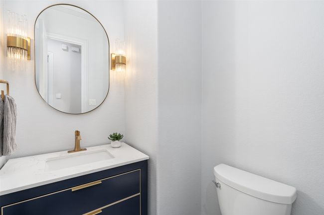 Guest bath has under mount sink, beautiful sconces and upgraded sink vanity. | Image 24
