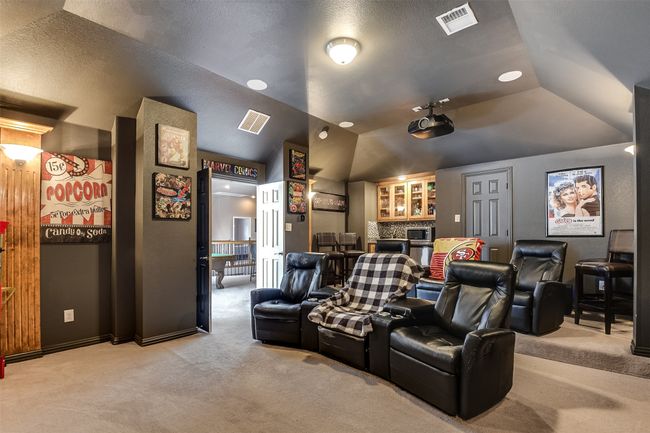 Carpeted home theater with vaulted ceiling | Image 36