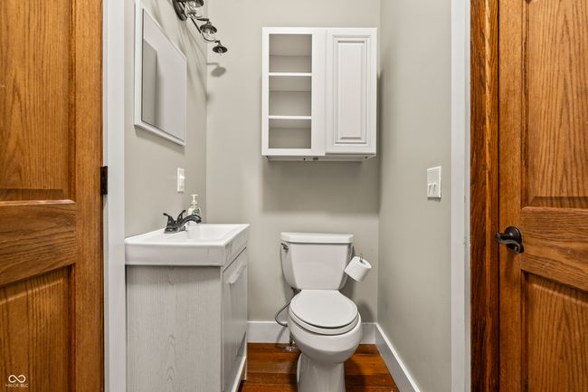 bathroom featuring vanity and dark wood finished floors | Image 23