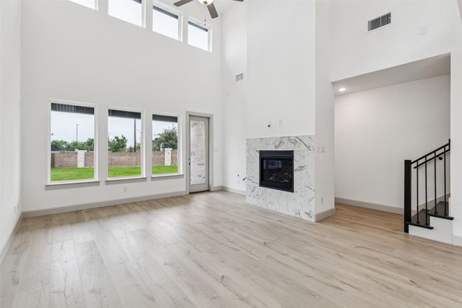 Featuring dual story windows, this home is flooded with natural light. | Image 9