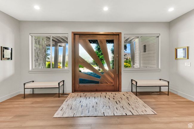 Entrance foyer featuring custom Pivot Door, wood floors and a large welcoming gallery feel. | Image 7