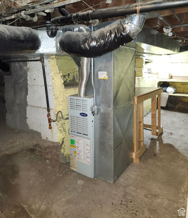 Basement with furnace, original rock foundation, work bench, and cold storage sleeving | Image 9