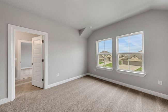 Spare room featuring carpet floors and lofted ceiling | Image 18