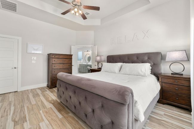 Bedroom featuring an ensuite bathroom. | Image 17