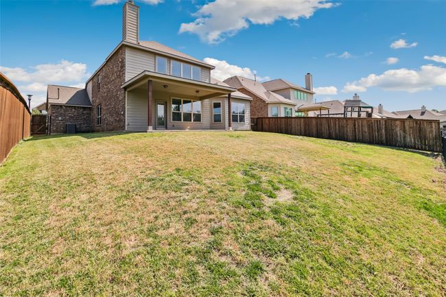 Back of house featuring a chimney, cooling unit, and brick siding | Image 35