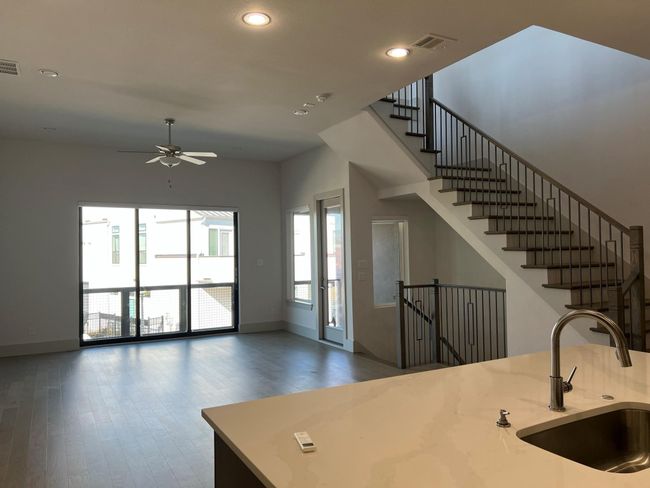 Kitchen featuring a sink, wood finished floors, a ceiling fan, recessed lighting, and baseboards | Image 5