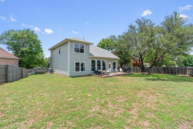 Rear view of property featuring central AC unit and a patio area | Image 36