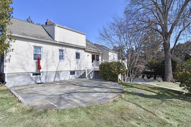 Back of house featuring a lawn, a chimney, a patio, and roof with shingles | Image 23