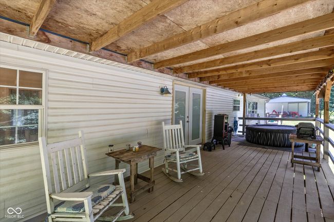 Another deck, covered runs along the back of the home. | Image 29