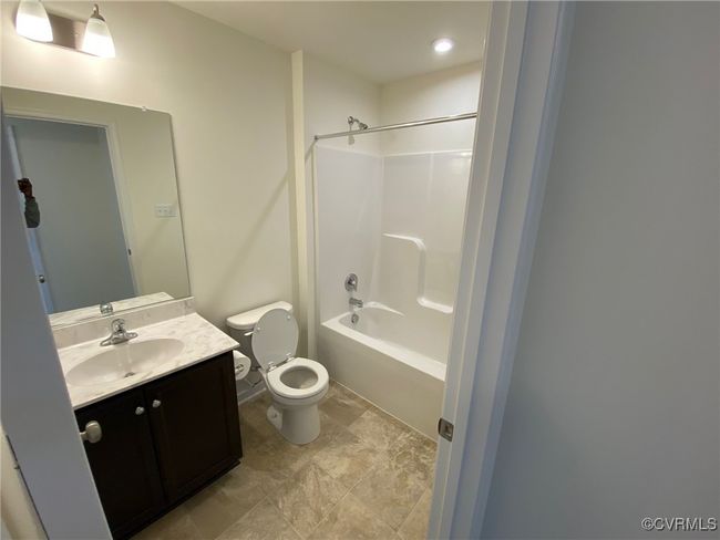 Bathroom with toilet, vanity, and shower / tub combination | Image 12