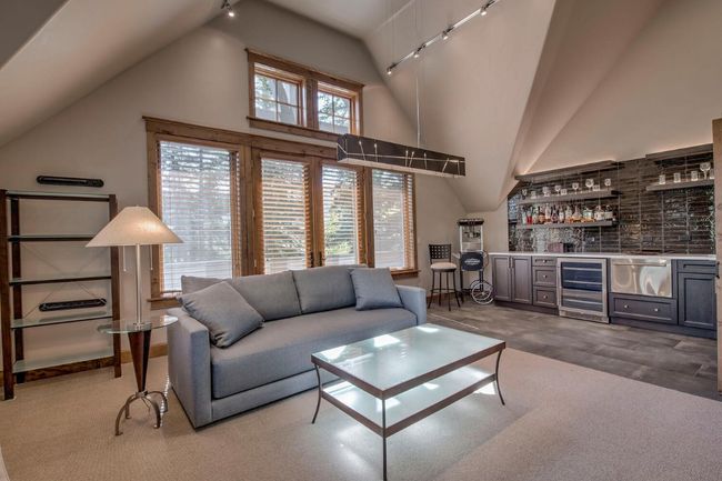 Play some games, or catch THE game, in this fun family room-complete with wet bar. | Image 24
