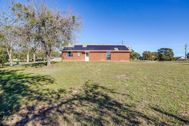 Rear view of property with a lawn and solar panels | Image 7