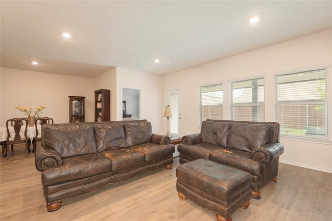 Living area with light wood finished floors and recessed lighting | Image 18
