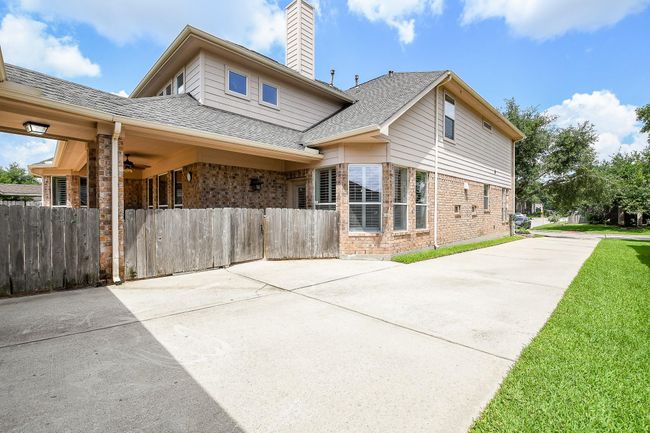 Long driveway leading to an oversized detached garage | Image 47