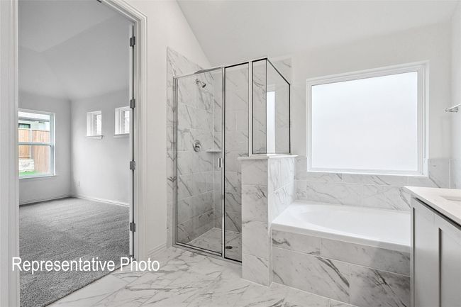 Bathroom with a bath, a stall shower, vaulted ceiling, marble finish floor, and vanity | Image 12