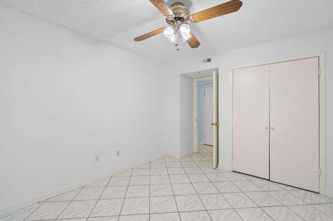 Unfurnished bedroom featuring visible vents, ceiling fan, a closet, and baseboards | Image 32