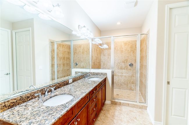 Full bathroom featuring a shower stall, tile patterned floors, and a sink | Image 18