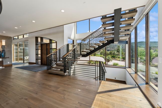 Staircase featuring baseboards, hardwood / wood-style flooring, recessed lighting, french doors, and a mountain view | Image 46