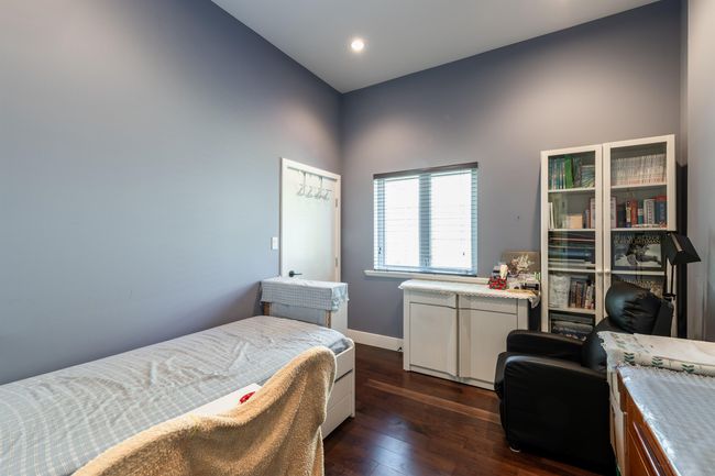 Bedroom with dark wood-style flooring, baseboards, and recessed lighting | Image 32