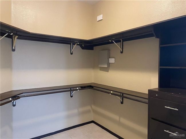Spacious closet featuring light tile patterned floors | Image 14