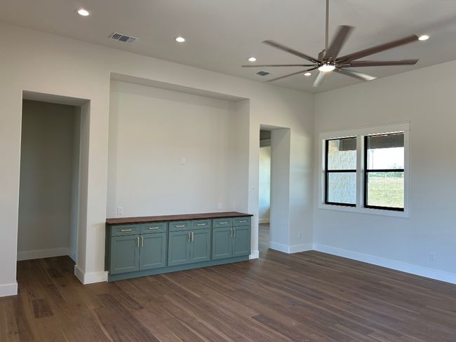 Unfurnished room featuring ceiling fan, dark wood-style flooring, baseboards, and recessed lighting | Image 11