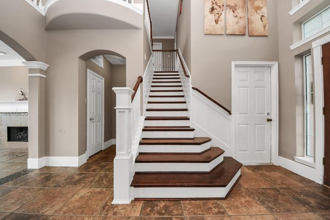 Stunning 2 story high ceiling entry with hard stained cherry solid oak floor steps. | Image 6