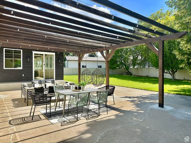 Fenced backyard with a pergola, outdoor lounge area, outdoor dining area, and a deck | Image 40