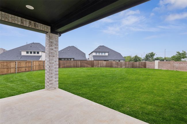 Dining al fresco is in your future on this lovely and spacious covered back patio! | Image 17