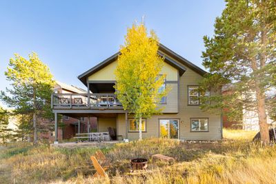 Back of property with an outdoor fire pit, a deck, and a patio area | Image 3