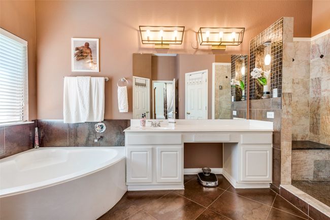 Primary bathroom features separate bathtub and walk in shower. | Image 17
