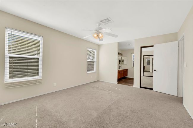 Empty room featuring carpet, visible vents, and ceiling fan | Image 23