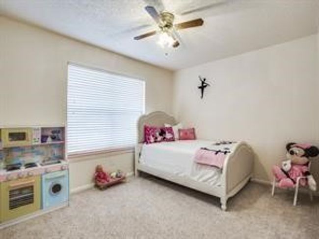Carpeted bedroom featuring a ceiling fan and baseboards | Image 5